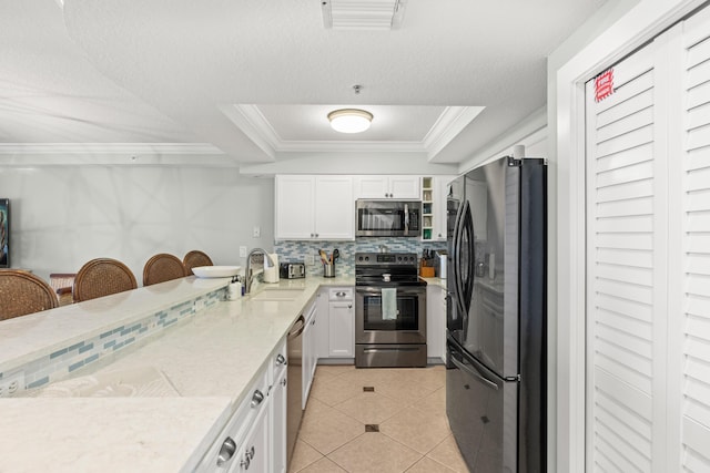 95 Coco Plum Dr Unit 5D, Marathon, FL 33050 - kitchen with stainless steel appliances, a sink, light countertops, white cabinets, and crown molding