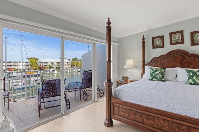 95 Coco Plum Dr Unit 5D, Marathon, FL 33050 - bedroom with access to exterior, crown molding, wood finished floors, and a water view