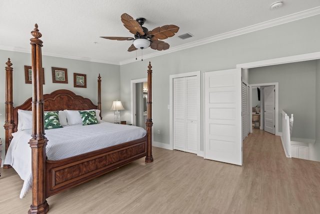 95 Coco Plum Dr Unit 5D, Marathon, FL 33050 - bedroom featuring light wood-type flooring, crown molding, ceiling fan, baseboards, and a textured ceiling