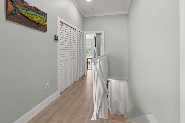 95 Coco Plum Dr Unit 5D, Marathon, FL 33050 - hallway with an upstairs landing, crown molding, wood finished floors, and baseboards