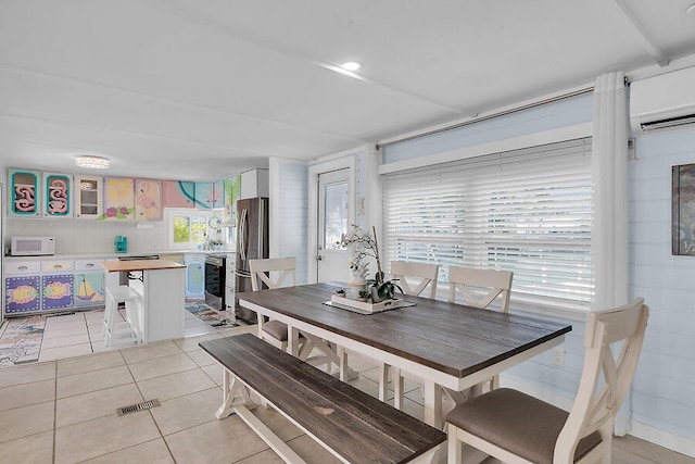 tiled dining area with a wall mounted AC