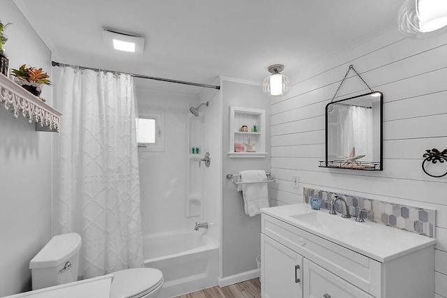 full bathroom with crown molding, shower / tub combo, vanity, wood-type flooring, and toilet