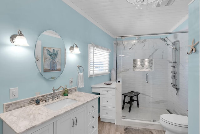 bathroom featuring toilet, an enclosed shower, wood-type flooring, ornamental molding, and vanity