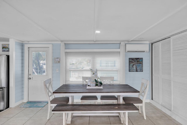 dining area featuring a wall mounted air conditioner and light tile patterned flooring