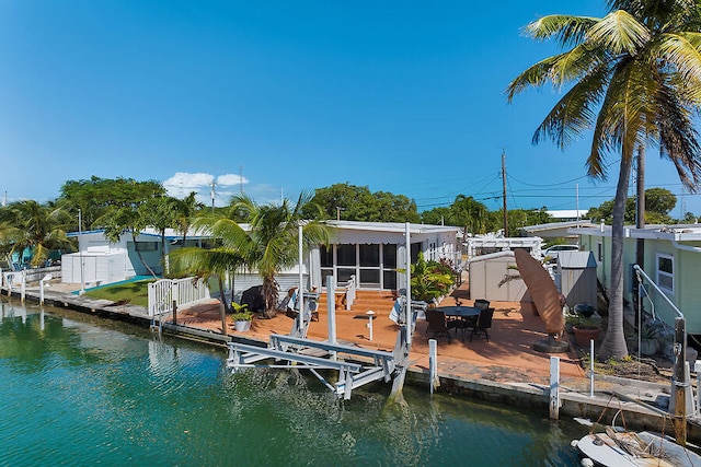 view of dock with a patio area and a water view