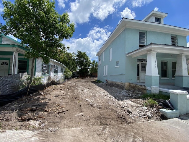 view of side of property with a porch