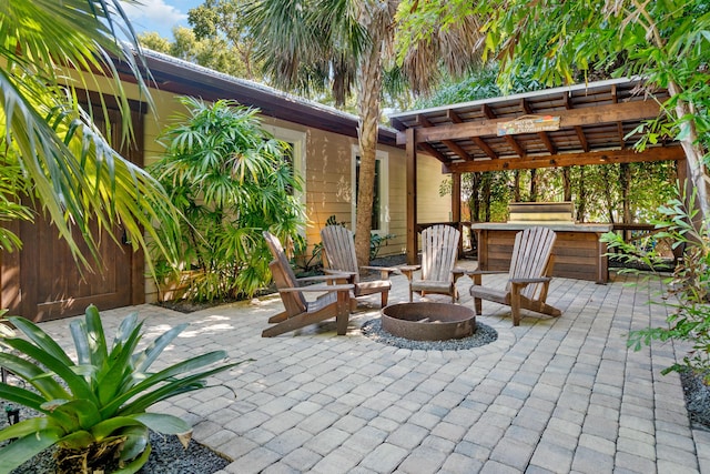 view of patio / terrace featuring an outdoor fire pit and a pergola