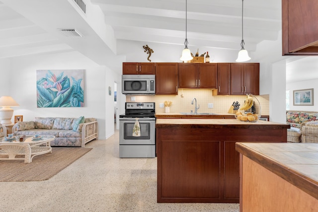 kitchen with pendant lighting, lofted ceiling with beams, sink, backsplash, and stainless steel appliances