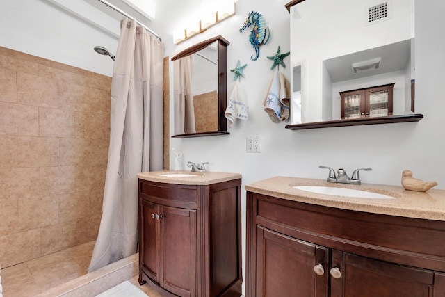 bathroom featuring vanity and curtained shower