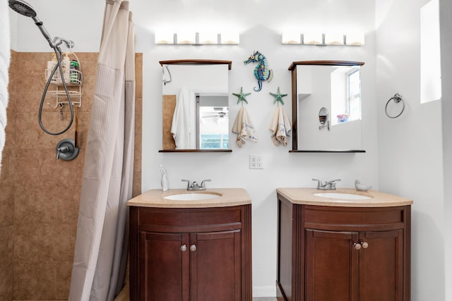 bathroom with vanity, curtained shower, and plenty of natural light