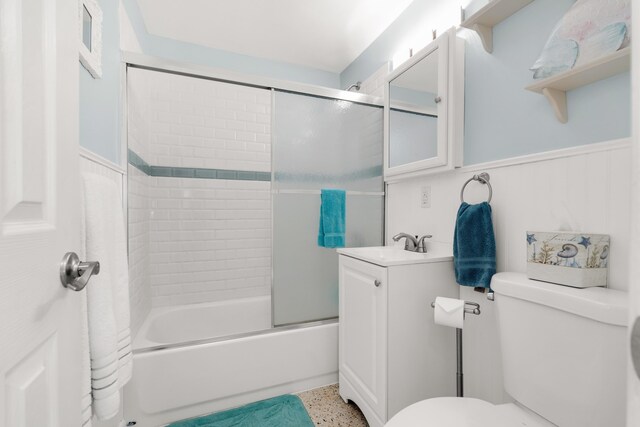 full bathroom featuring vanity, enclosed tub / shower combo, and toilet