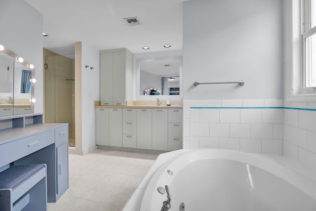 bathroom featuring vanity and shower with separate bathtub