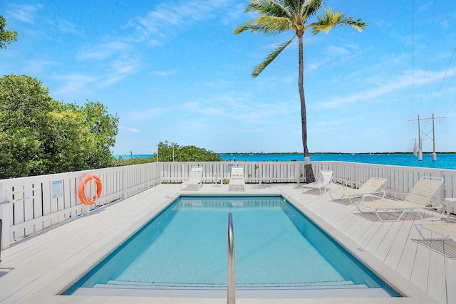 view of swimming pool featuring a water view