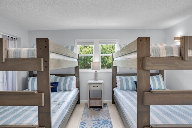 bedroom featuring a textured ceiling and light tile patterned floors