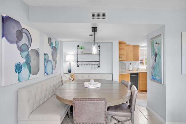 dining area with light tile patterned floors