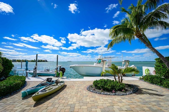 view of patio / terrace with a water view and a boat dock