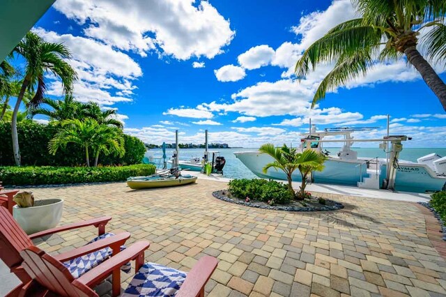 view of patio / terrace featuring a water view and a dock