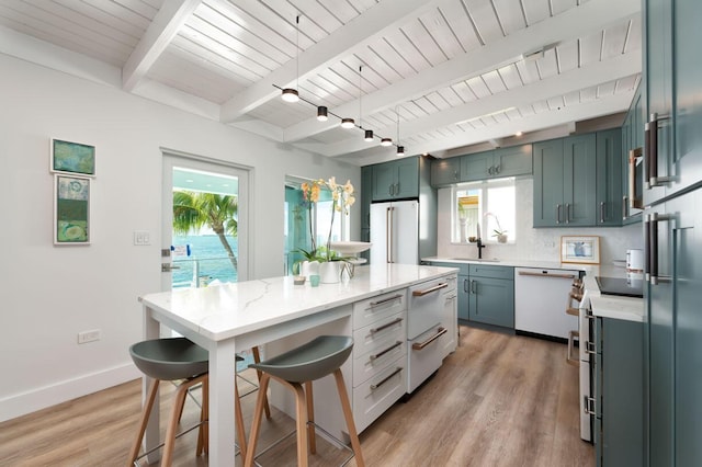 kitchen featuring beam ceiling, plenty of natural light, high end refrigerator, and white dishwasher