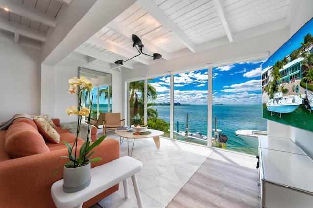 sunroom / solarium with wood ceiling, beam ceiling, and a water view