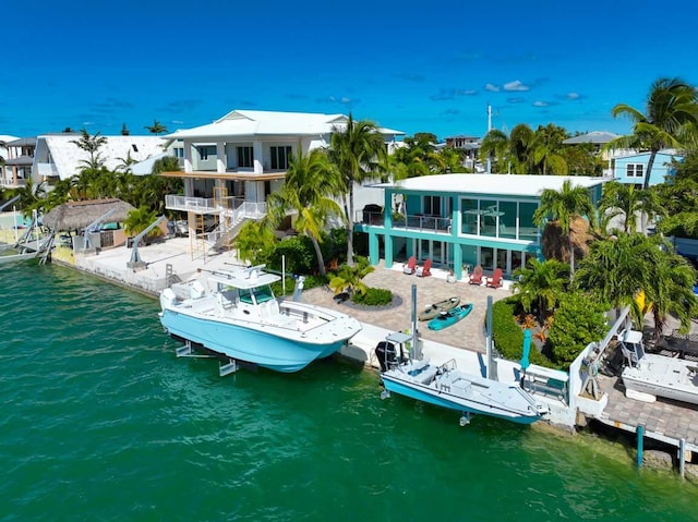 back of property featuring a water view