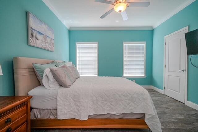 bedroom featuring hardwood / wood-style flooring, crown molding, and ceiling fan