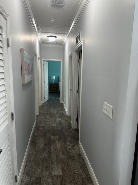 hall featuring crown molding and dark hardwood / wood-style floors