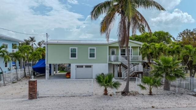 coastal home with a garage and covered porch