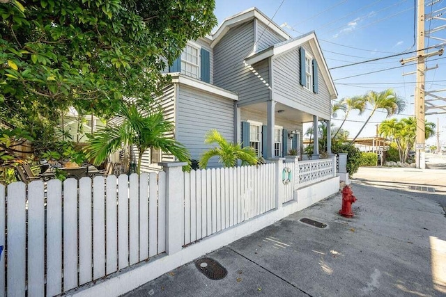 view of side of home featuring covered porch