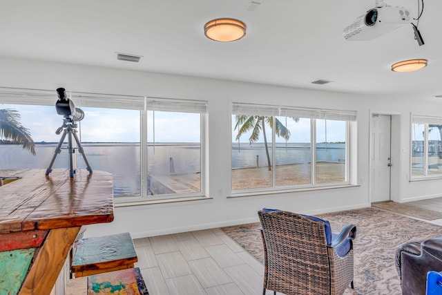 sunroom / solarium with a water view