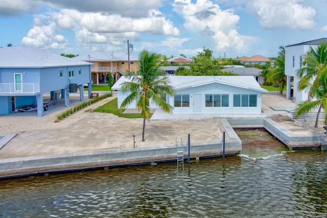 back of house featuring a water view and central AC unit