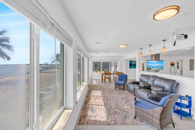 living room with a water view and sink