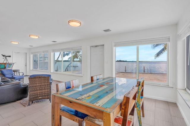 dining room featuring a water view