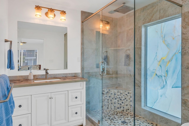 bathroom featuring vanity and a shower with door