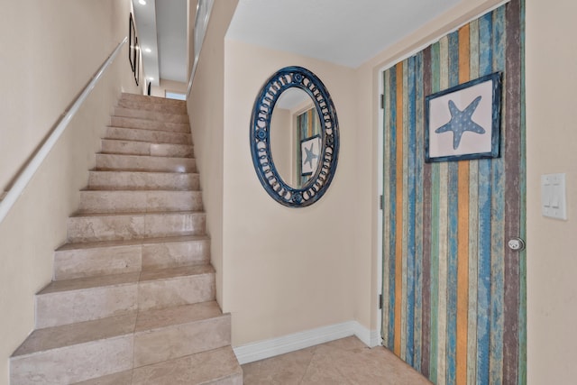 stairway with tile patterned floors