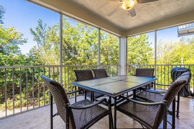 sunroom featuring ceiling fan