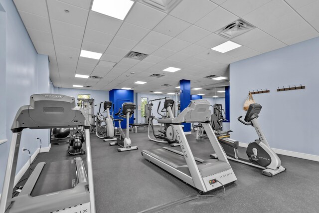 exercise room with a paneled ceiling