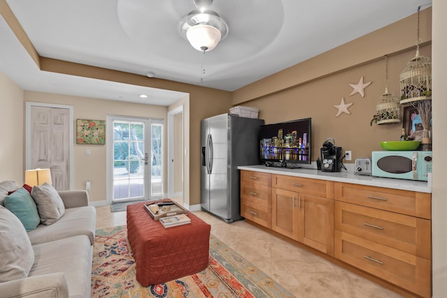 interior space featuring pendant lighting and stainless steel refrigerator with ice dispenser