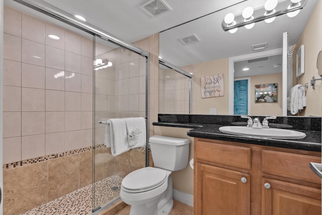 bathroom featuring toilet, vanity, and walk in shower