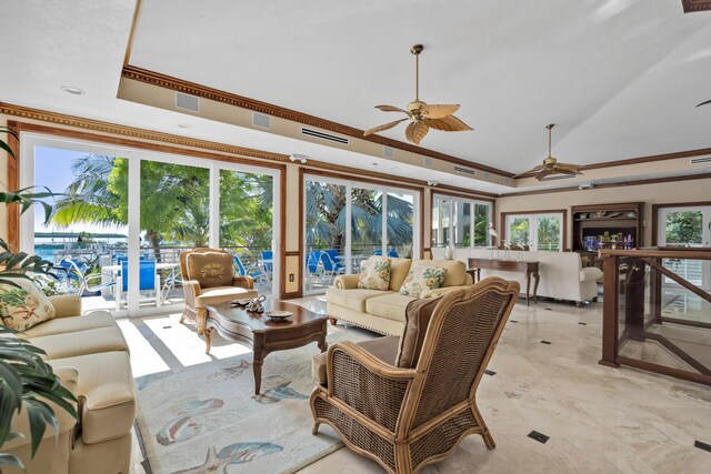 living room with vaulted ceiling, a raised ceiling, and ceiling fan