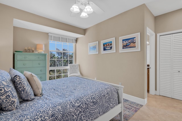 bedroom with ceiling fan, a closet, and light tile patterned floors