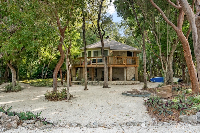 rear view of house featuring a deck