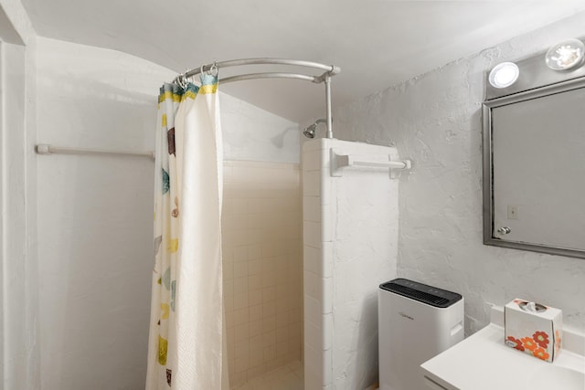 full bathroom featuring a textured wall and a stall shower
