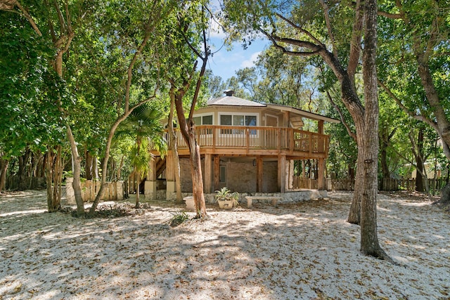exterior space with a wooden deck and a chimney