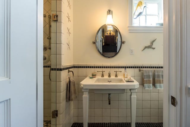 bathroom featuring wainscoting and tile walls