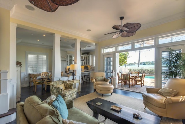 sunroom / solarium with a ceiling fan, a wealth of natural light, and ornate columns