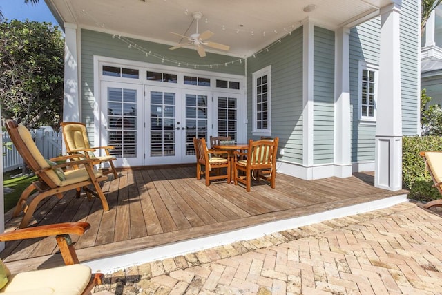 wooden deck featuring french doors and a ceiling fan