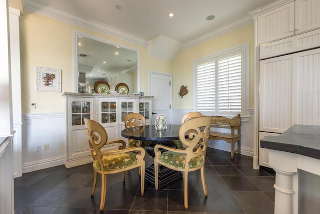 dining room with a wainscoted wall, recessed lighting, ornamental molding, and dark tile patterned flooring