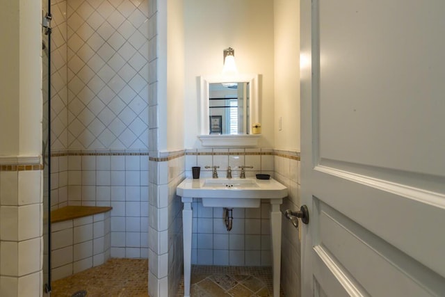 bathroom with a wainscoted wall and tile walls