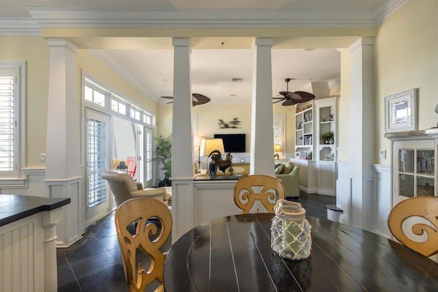 dining room featuring decorative columns, ornamental molding, and ceiling fan