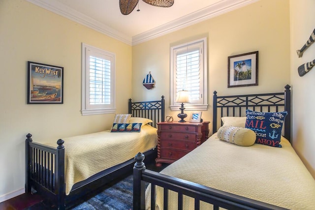 bedroom with ornamental molding and baseboards